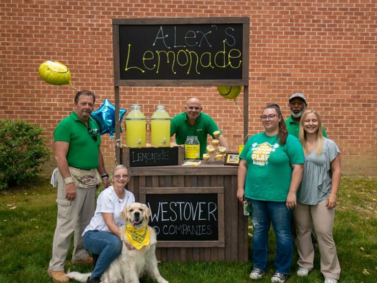 Volunteers posing at the Alex's Lemonade stand